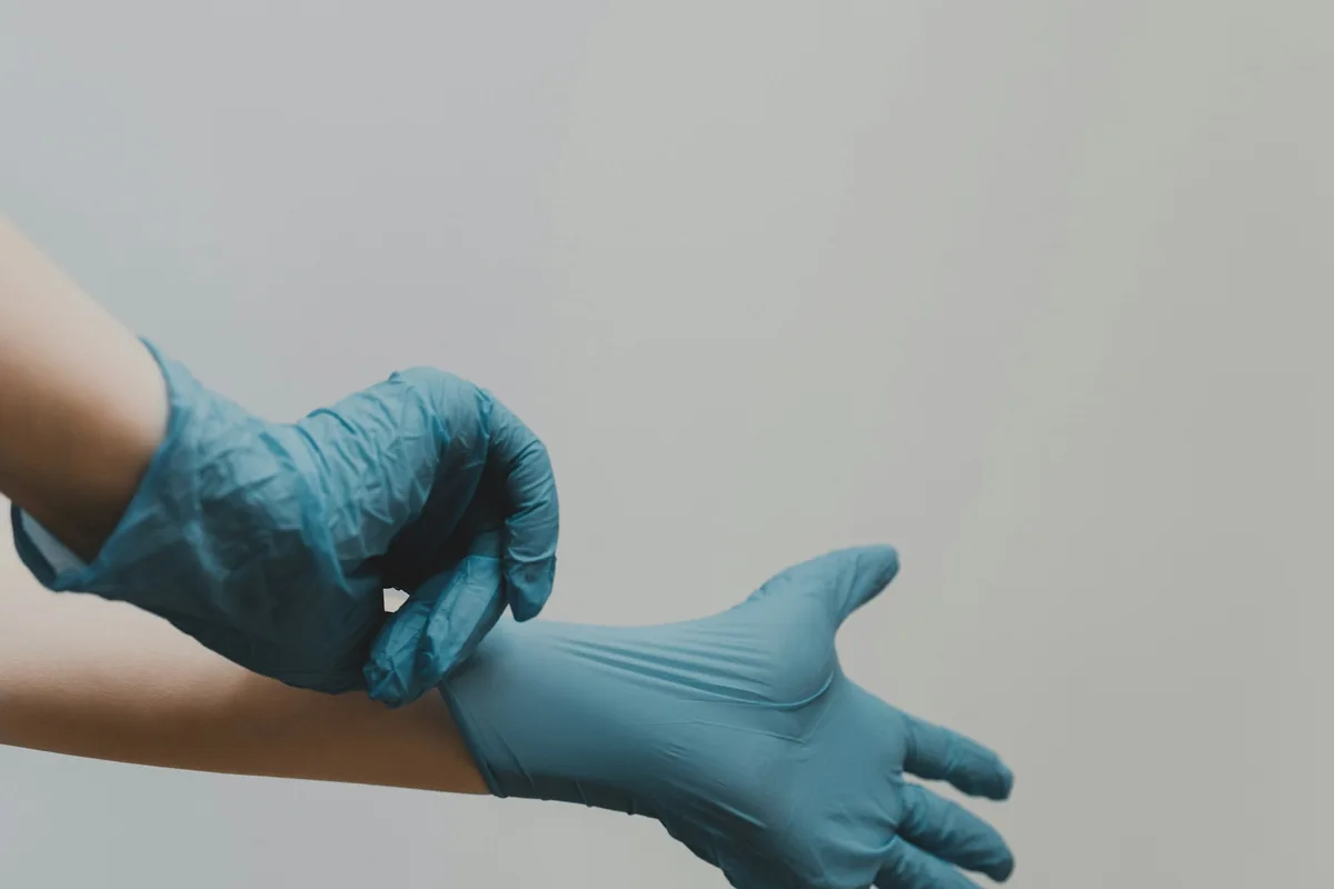 Gloved hands prepared for remediation work